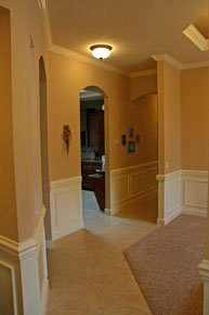 Gainesville FL Architect, custom home hallway design with crown molding and wainscoting, arches